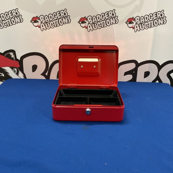 Red metal lockbox with keyhole, vintage storage solution.