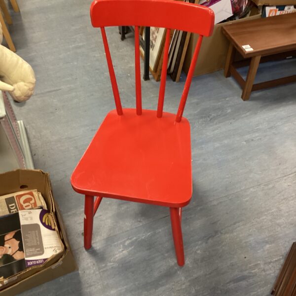 Red stick back chair with a vintage farmhouse style.
