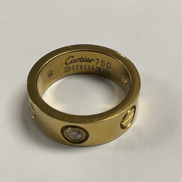 Gold tone reproduction Love Ring, size J.