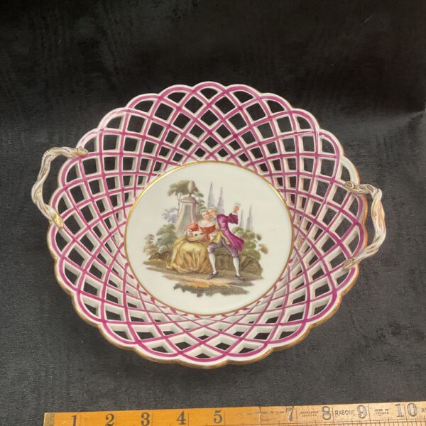 Antique German reticulated porcelain basket with hand-painted scene.