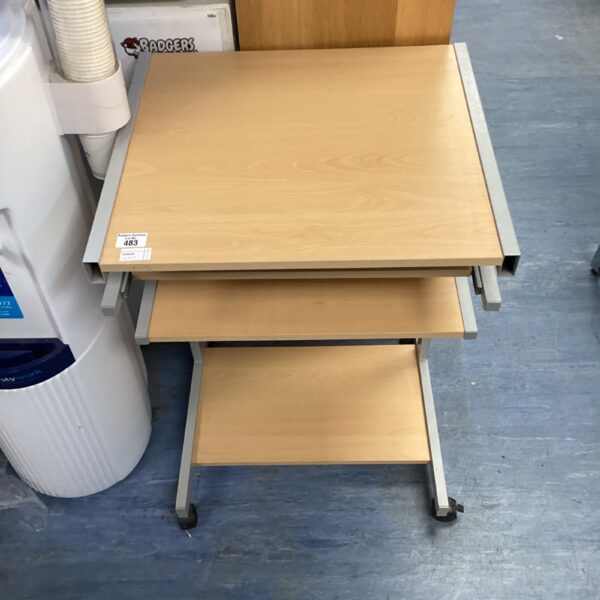 Silver and wood rolling computer desk with lower shelf.