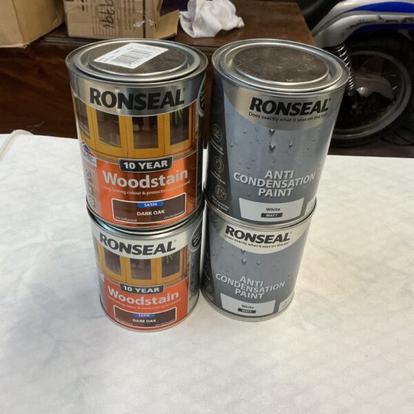Four tins of Ronseal Dark Oak woodstain and anti condensation paint.