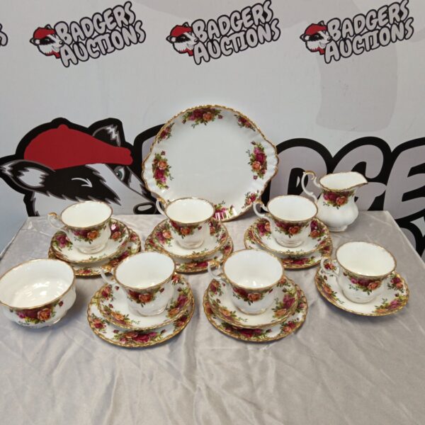 Royal Albert Country Rose tea set displayed on a white surface.