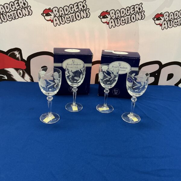 Set of four Royal Doulton crystal wine glasses on display.