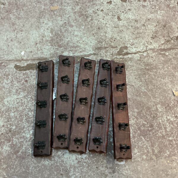 Set of five rustic wooden coat hooks for farmhouse decor.