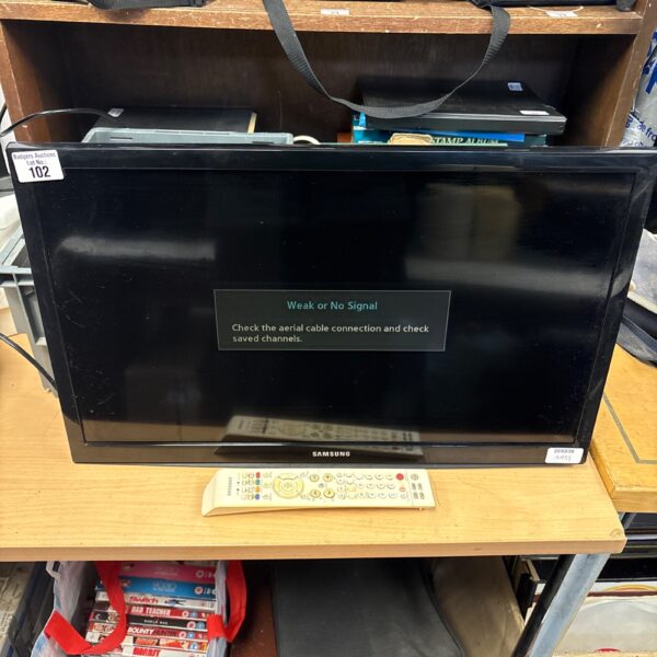 Samsung 24 inch TV UE24H400AW with remote control for home entertainment.