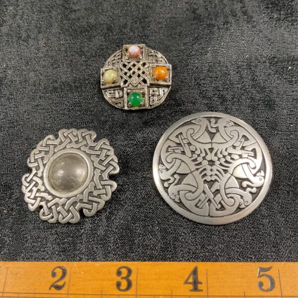 Vintage Scottish brooches with Celtic designs and agate accents.