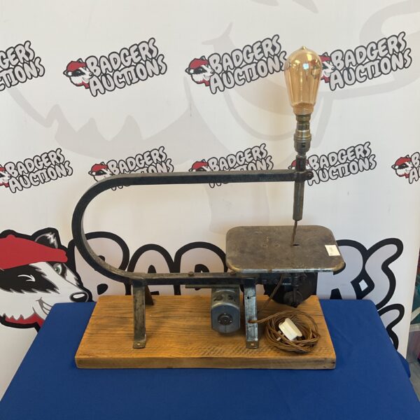 Vintage steampunk scroll saw lamp with metal shade.