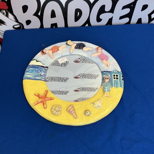 Vintage seaside wall mirror with a playful beach theme.