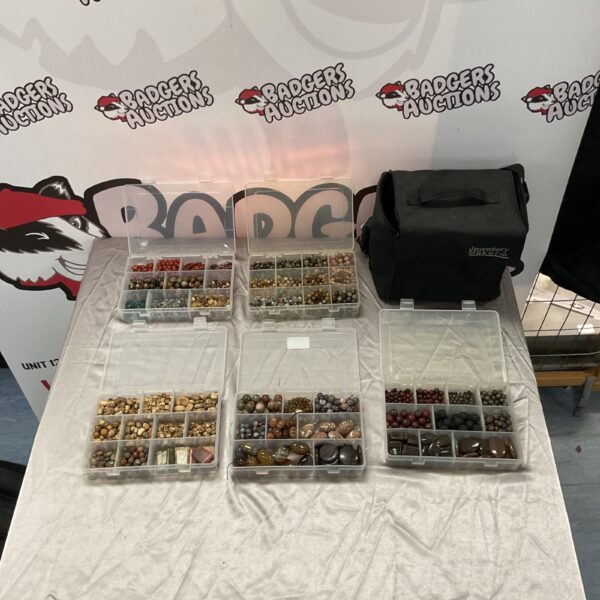 Assorted semi-precious stones in tubs for jewellery making.