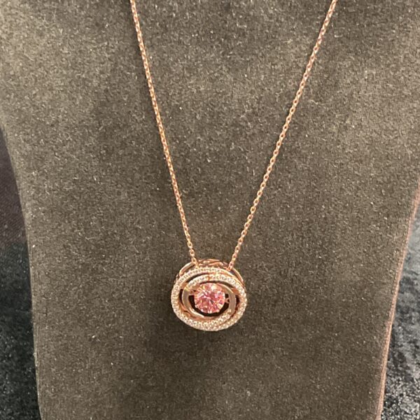 Close-up of a silver gilt shimmerstone pendant necklace.