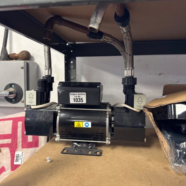 Side view of a Stuart Turner Showermate pump with connections.
