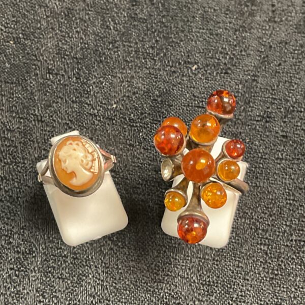 Vintage silver rings with amber and cameo detail.
