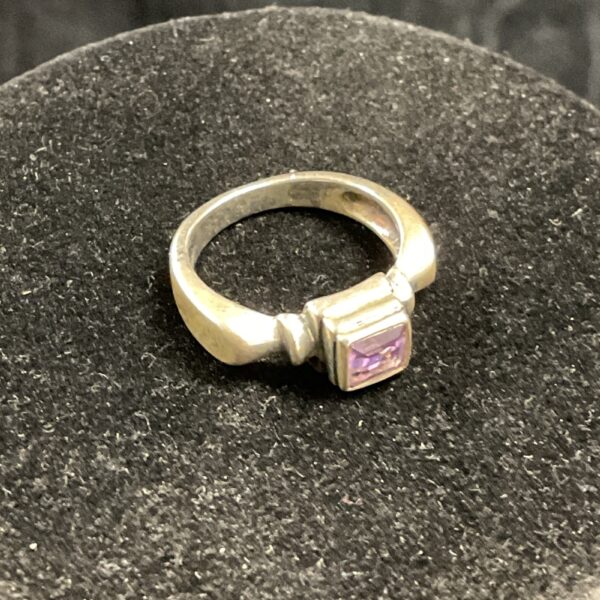 Silver ring with a vibrant amethyst gemstone.
