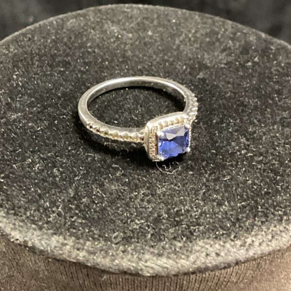 Silver ring with a vibrant blue stone, size O.