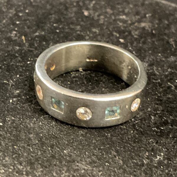 Elegant 925 silver ring with blue topaz and cubic zirconia stones.
