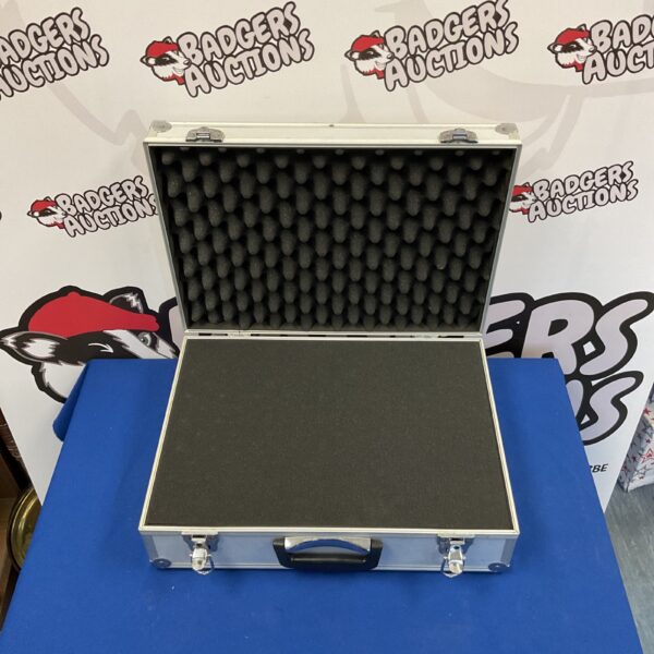 Silver briefcase with foam lining for secure equipment transport.