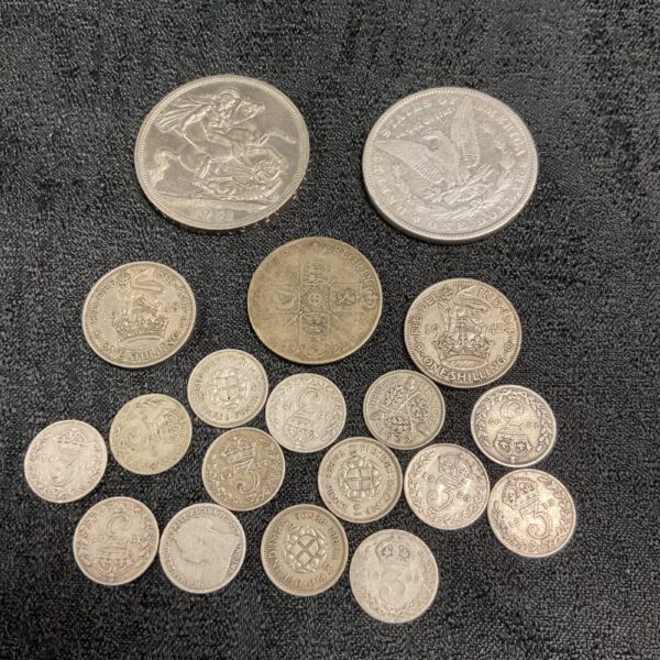 Silver coin collection featuring a 1951 Crown and 1887 dollar.