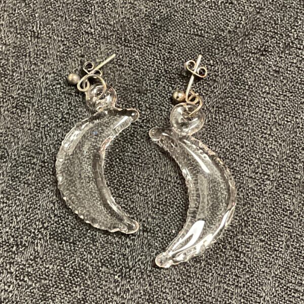 Delicate silver crescent earrings with crystal accents.