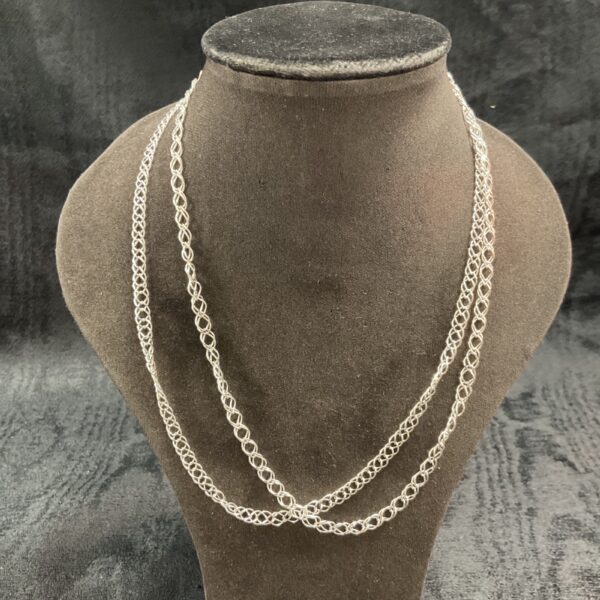 Pair of 925 silver double link necklaces on display.