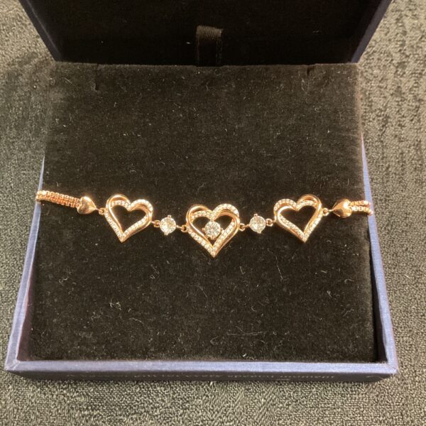 Silver gilt heart bracelet on display, delicate jewellery.