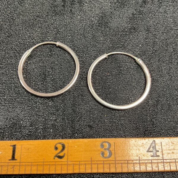 Pair of large silver hoop earrings, classic jewellery.