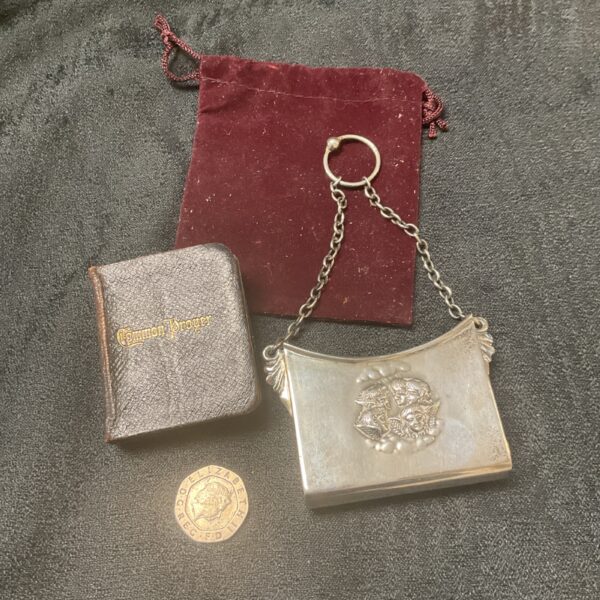 Antique silver miniature finger purse with a prayer book inside.