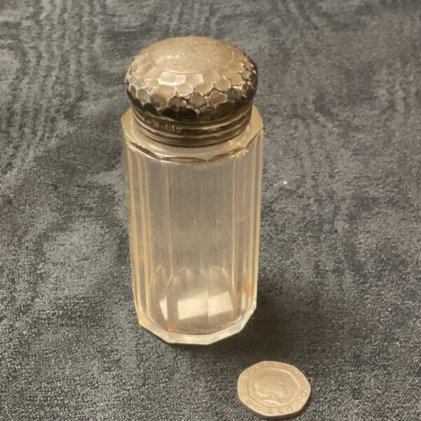 Antique silver mounted pin bottle with faceted glass design.