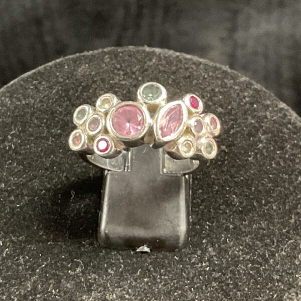 Colourful silver cluster ring with multiple stones.