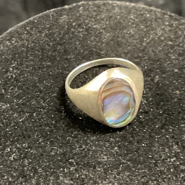 Iridescent paua shell set in a 925 silver ring, size L.