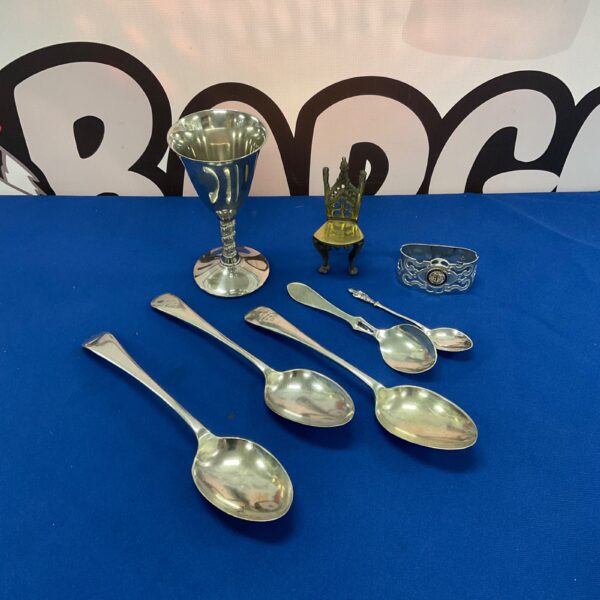 Antique silver plate collection featuring a goblet and spoons.