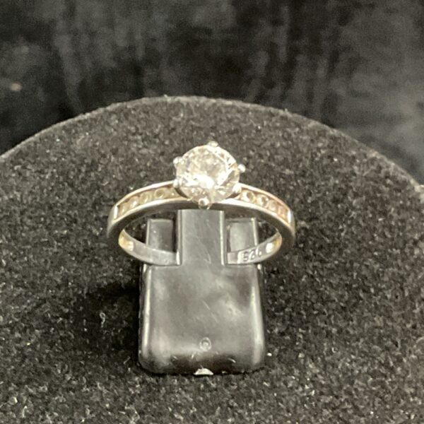 Silver ring with large white stone, size T.