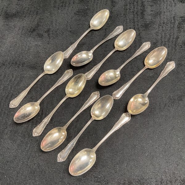Vintage silver teaspoon set, ornate handles, collectible silverware.