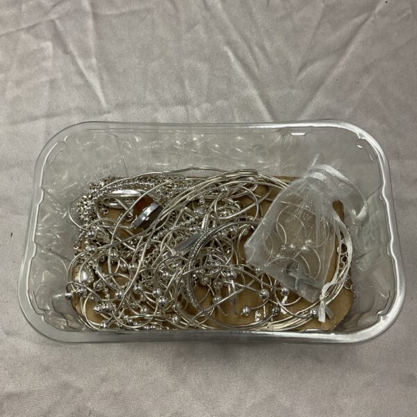 Silver tone jewellery lot including necklaces and a bangle.