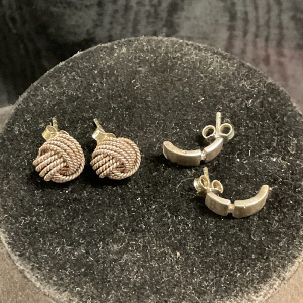 Close-up of silver twisted knot stud earrings.
