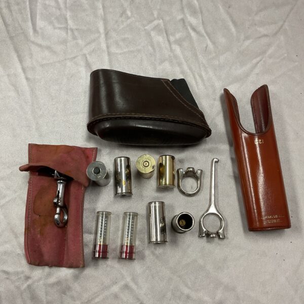 Vintage snap caps and leather gun accessories collection.