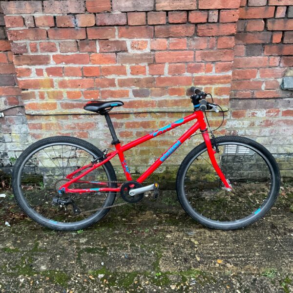 Red Squish child’s mountain bike, ideal for outdoor adventures.