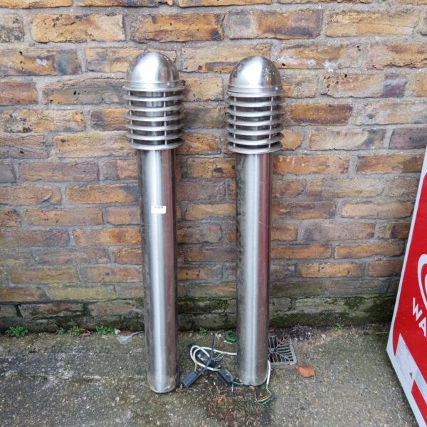 Pair of stainless steel gate post lights for garden illumination.