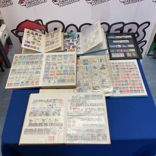 Overview of seven stamp albums filled with stamps.