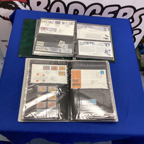 Two stamp and first aid cover albums for collectors.