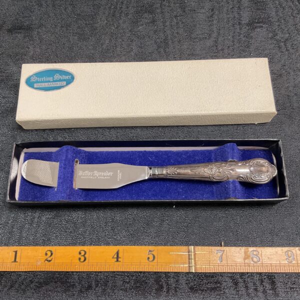 Hallmarked sterling silver butter knife with floral handle.