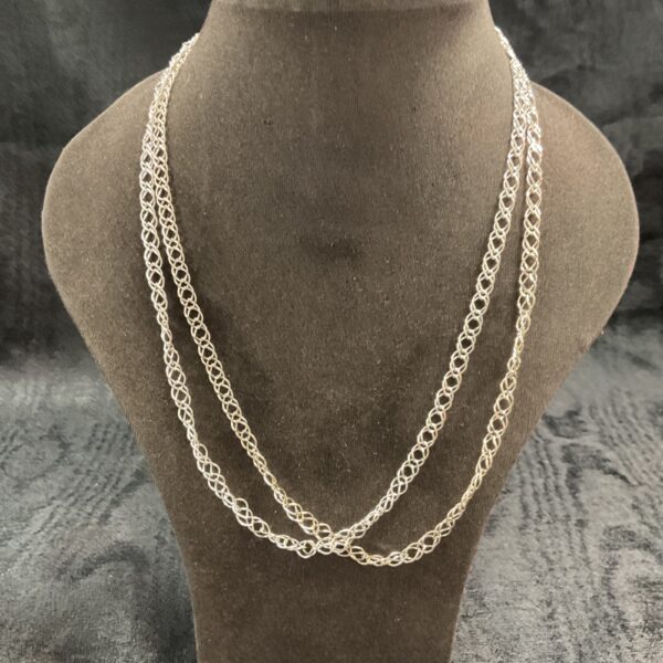 Two sterling silver double link necklaces on a display bust.