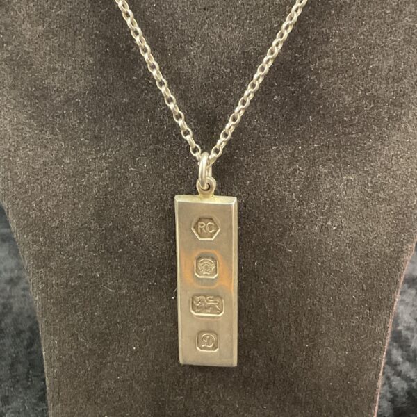 Hallmarked sterling silver ingot pendant on a silver chain.