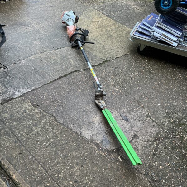 Used Stihl petrol strimmer with hedge cutter attachment for garden maintenance.