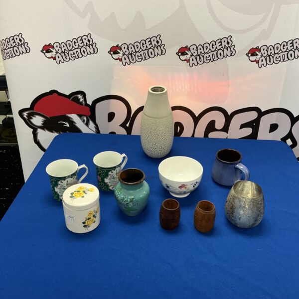 Diverse studio pottery collection with colourful bowls and vases.