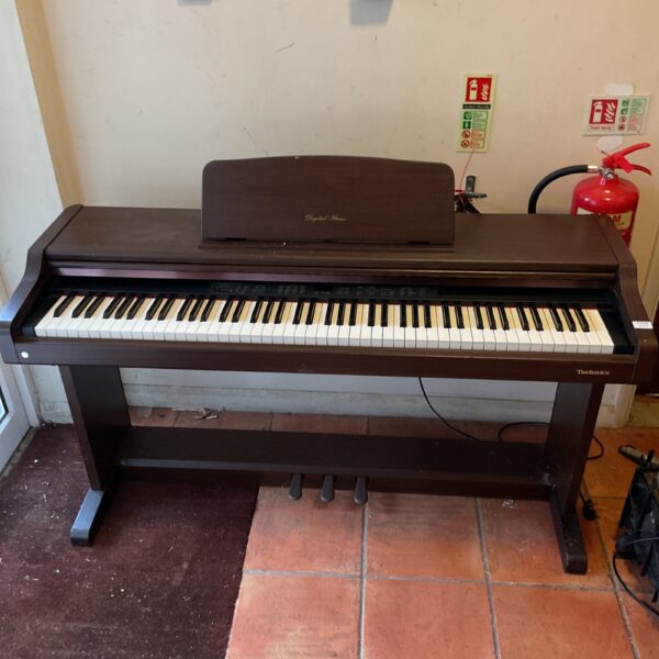 Technics PX103 digital piano in a home setting.