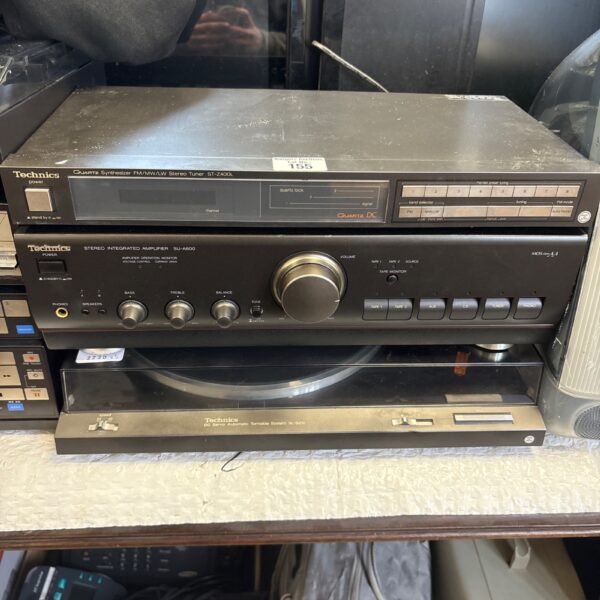 Vintage Technics stereo system with turntable, amplifier, and tuner.