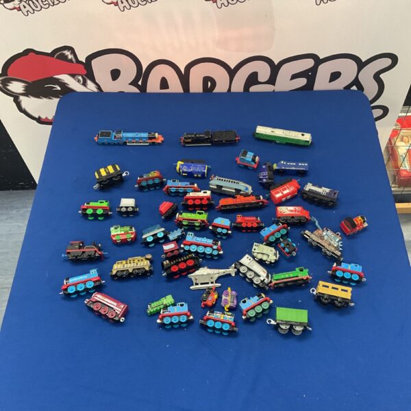 Colourful lot of Thomas the Tank Engine toy trains for collectors.