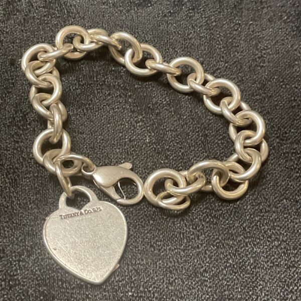 Vintage Tiffany and Co silver heart link bracelet, close-up view.