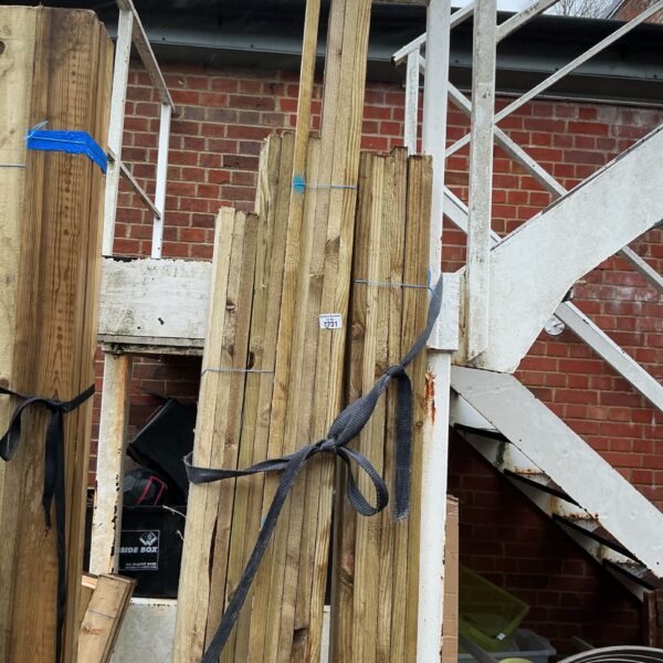 Three bundles of timber secured with strapping outdoors.